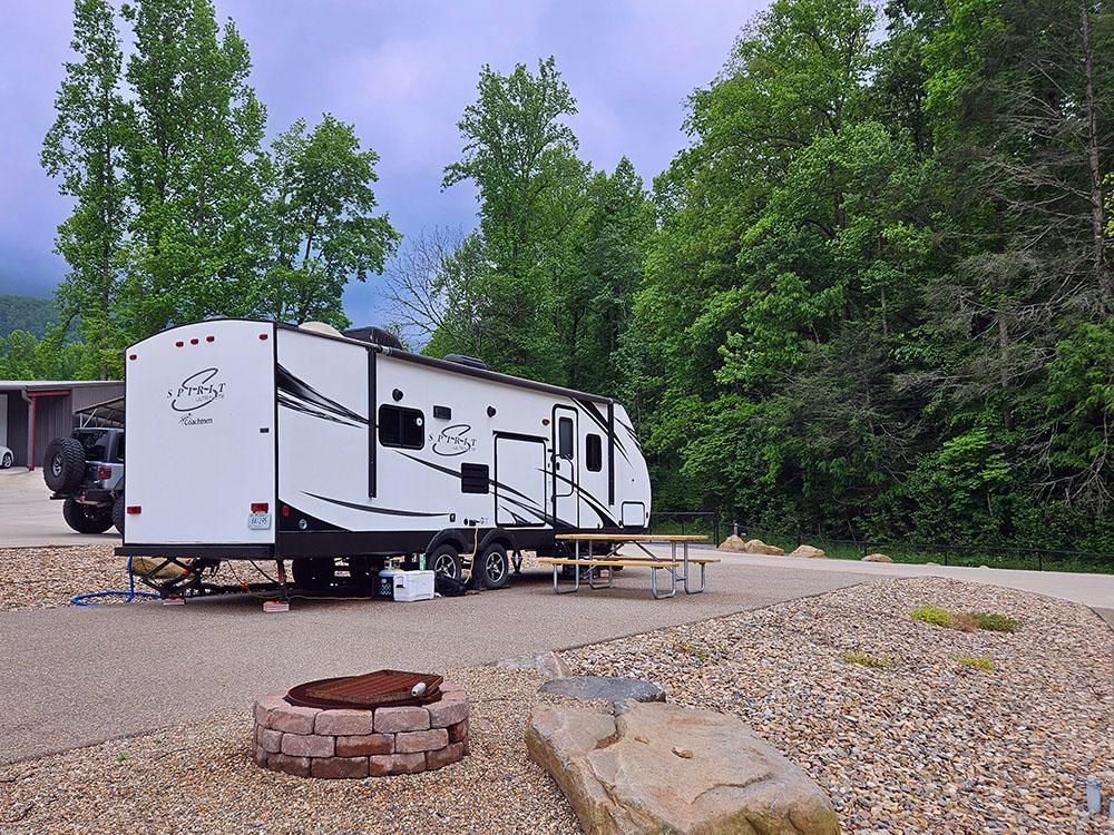 A trailer parked with a table at the site at SMOKY MOUNTAIN PREMIUM CAMPING