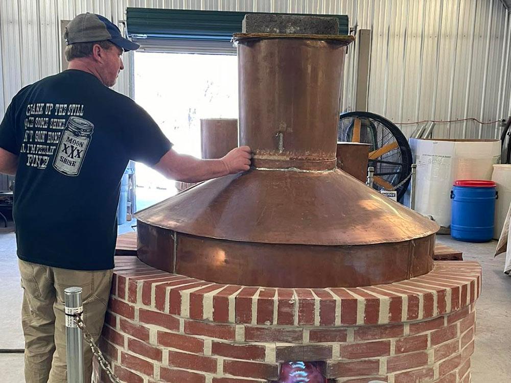 A man touching the Still at SMOKY MOUNTAIN PREMIUM CAMPING