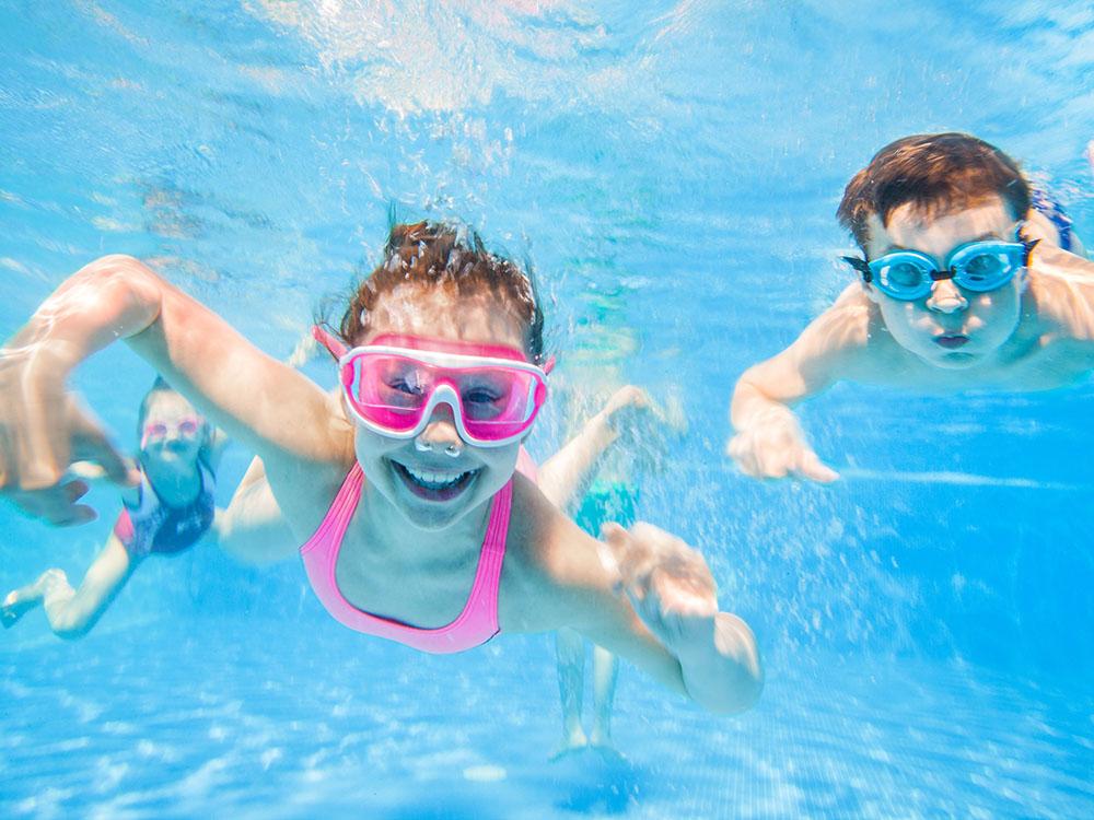 Kids swimming under water at SANDUSKY RV RESORT