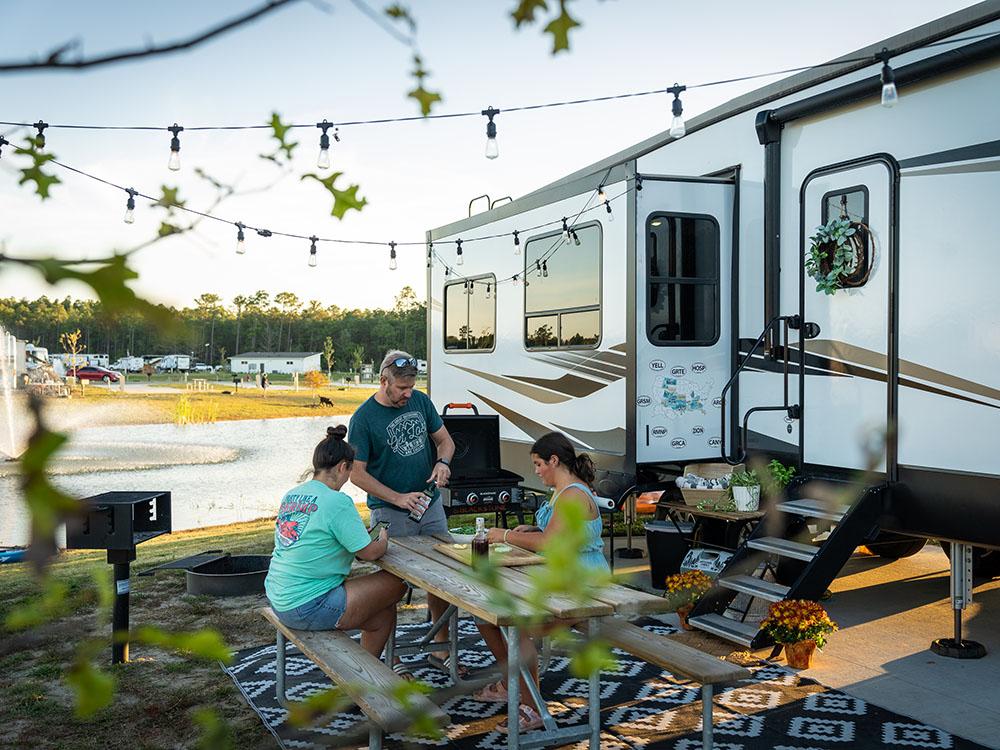 Family preparing a meal at a picnic at SANDUSKY RV RESORT