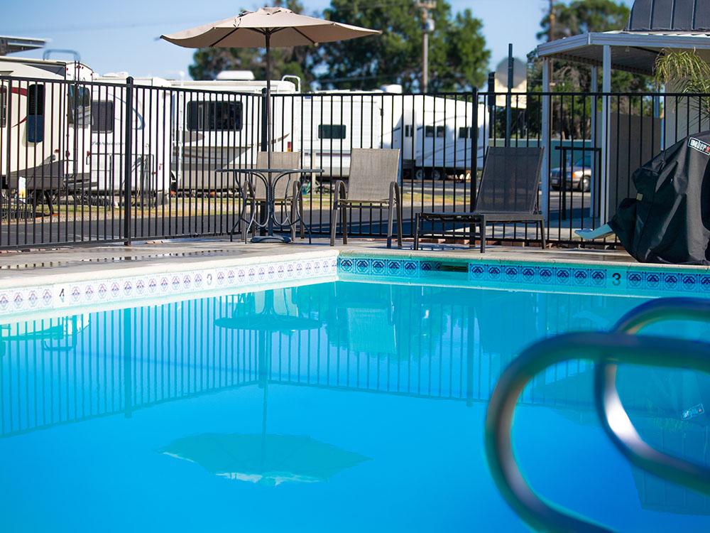 Pool area with table and chairs at ROSEDALE VILLAGE RV PARK