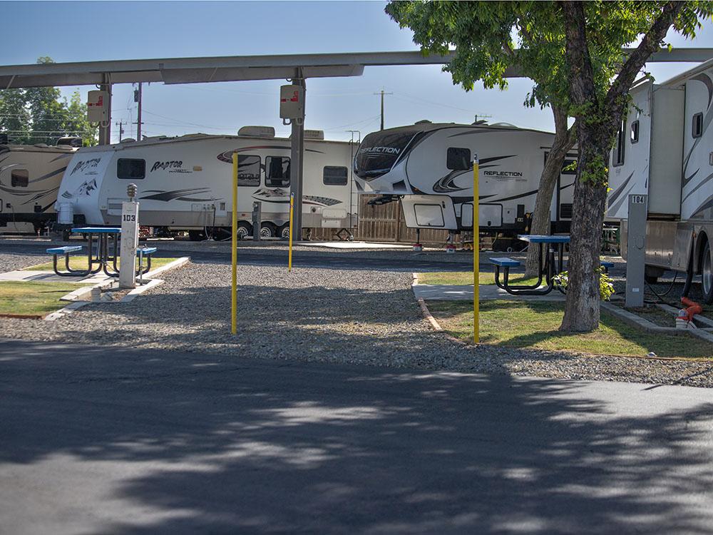 Travel trailers parked on gravel sites at ROSEDALE VILLAGE RV PARK