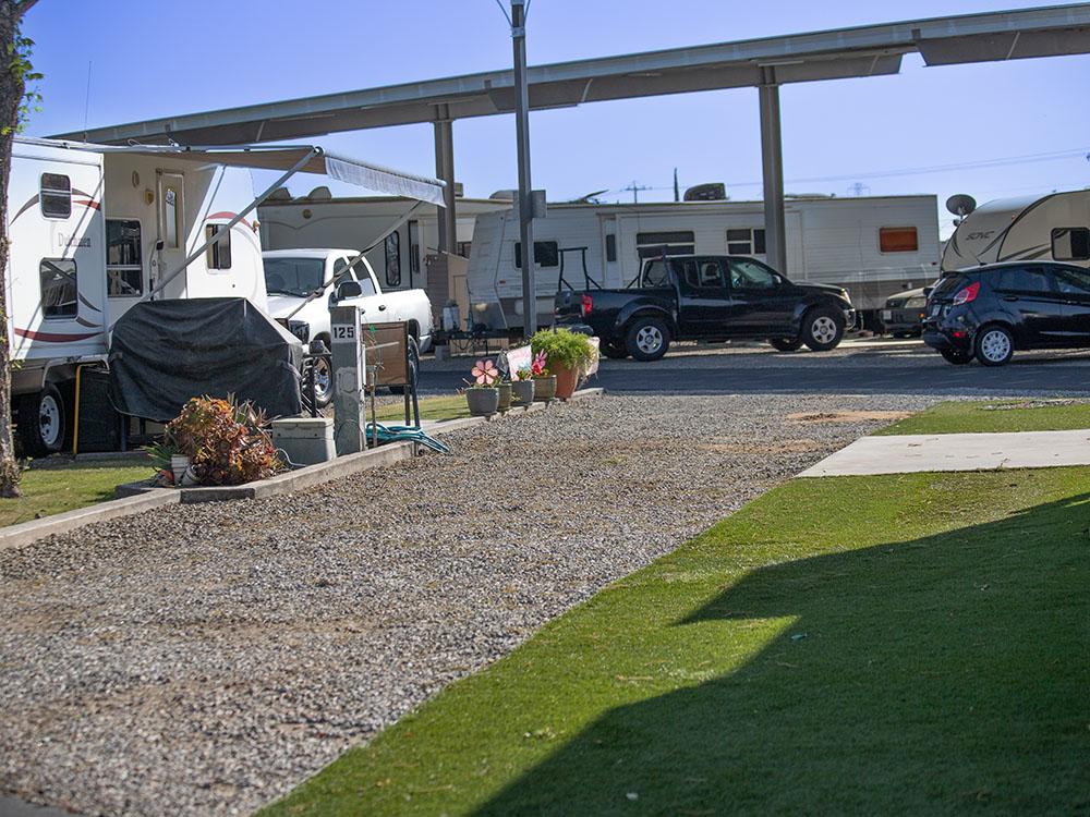 Grassy area next to gravel site at ROSEDALE VILLAGE RV PARK