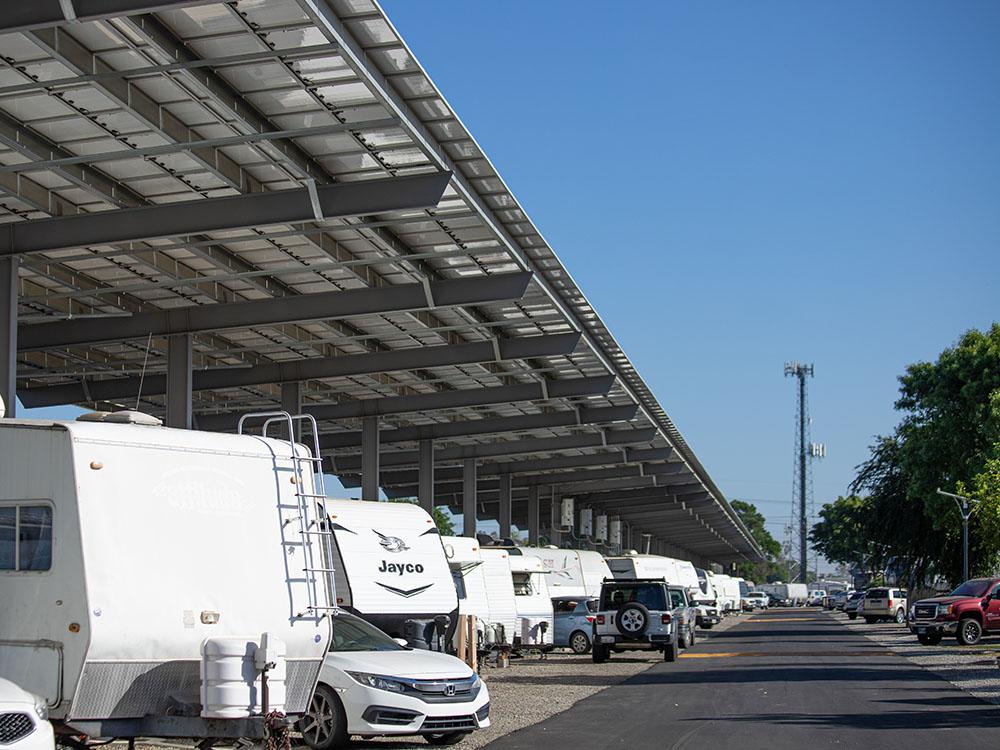 Travel trailer parked under an awning at ROSEDALE VILLAGE RV PARK