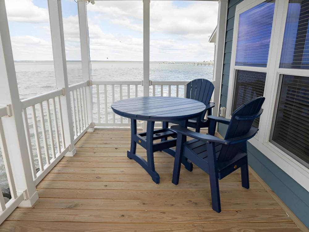 Seating area on patio with water view at BluFin Bungalows & Marina