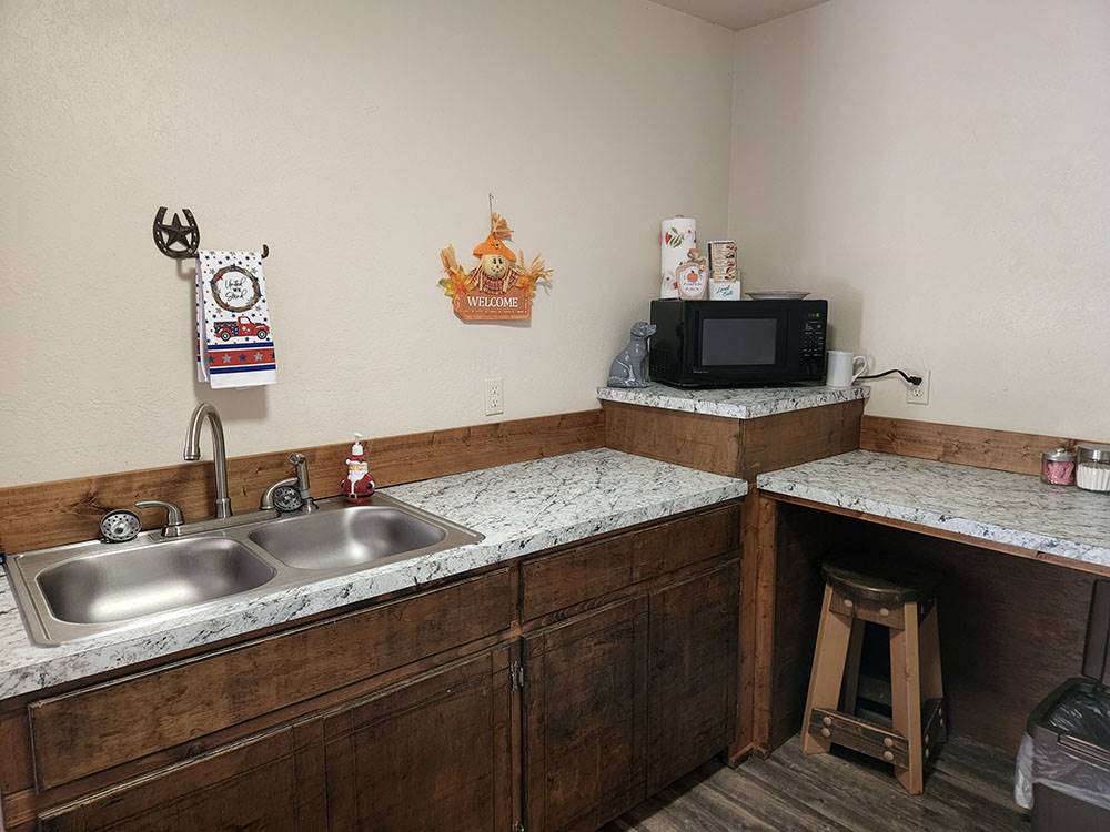 Kitchen sink and microwave at The Bunkhouse Cabins and RV Park