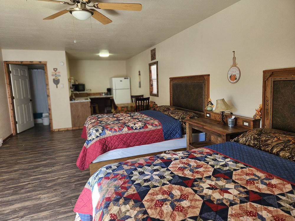 Cabin with two beds and kitchenette at The Bunkhouse Cabins and RV Park