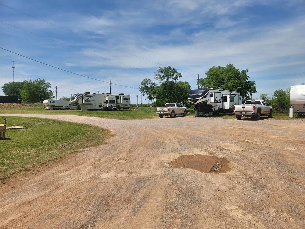 Travel trailers and trucks at sites at The Bunkhouse Cabins and RV Park