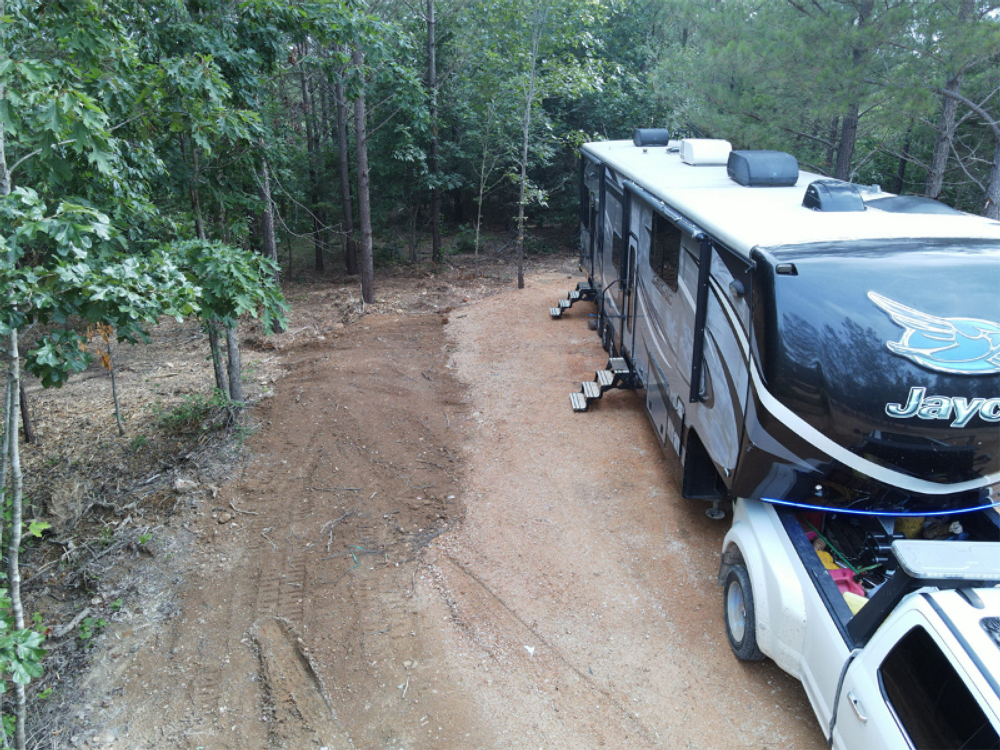 5th wheel in a dirt site at Harmony Ridge RV Park