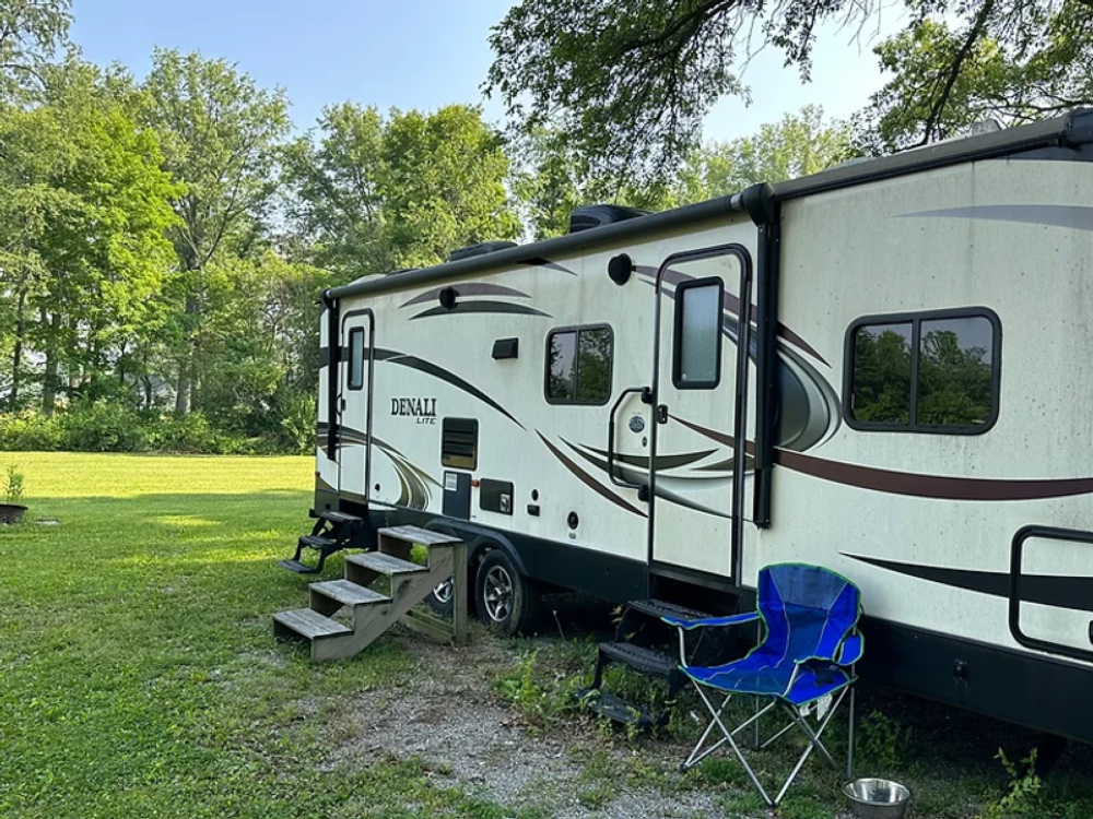 Trailer in grass site at Winona Lake Campground