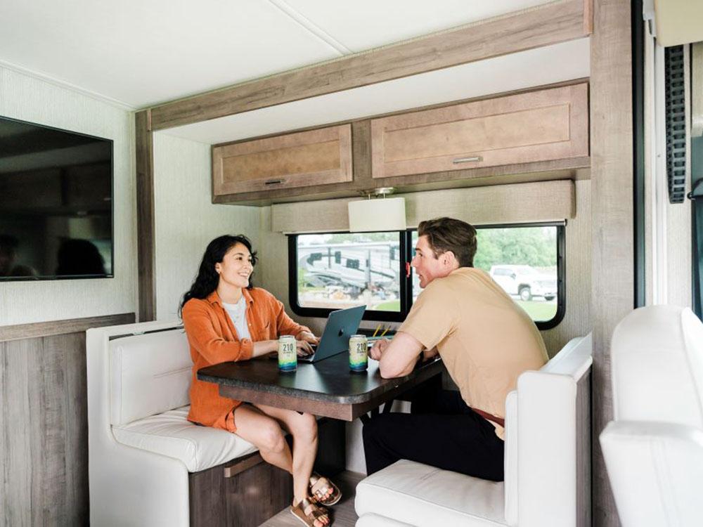 A couple sitting at the table in their RV at ANGEL OF THE WINDS CASINO RESORT