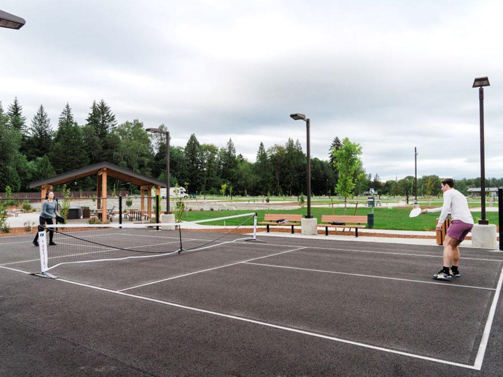 A couple playing pickle ball at ANGEL OF THE WINDS CASINO RESORT