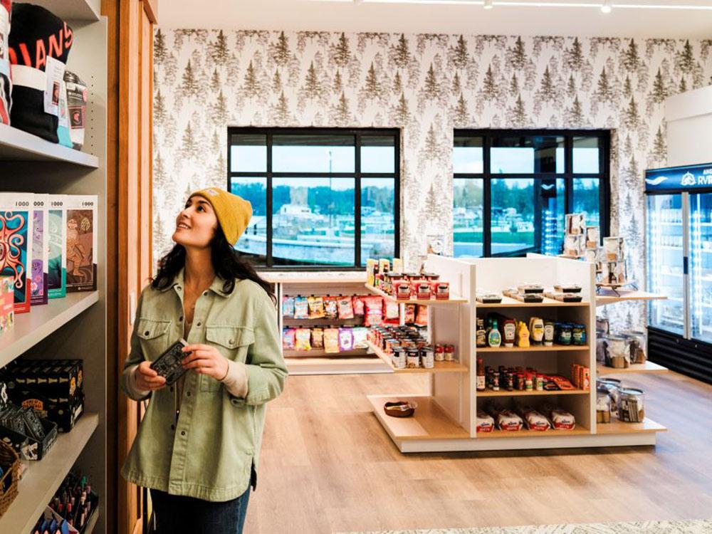 A woman browsing in the park store at ANGEL OF THE WINDS CASINO RESORT