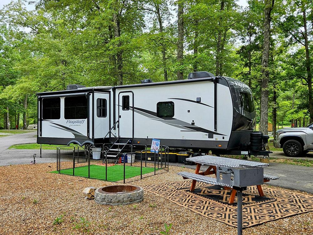 Trailer with picnic table and fire ring at MOUNTAIN TOP RV PARK