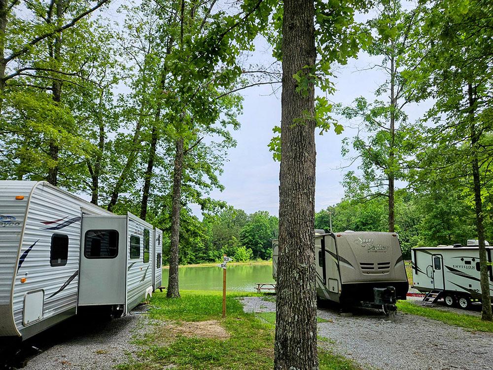 Gravel sites by trees at MOUNTAIN TOP RV PARK