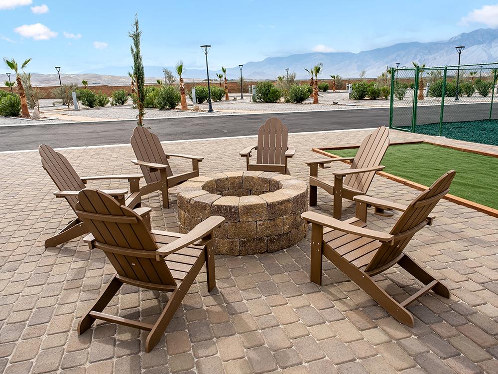 Chairs around a fire pit at PARADISE RV PARK