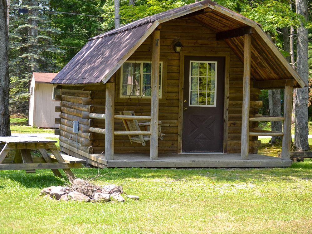 Picnic table next to a cabin at KINZUA EAST KAMPGROUND