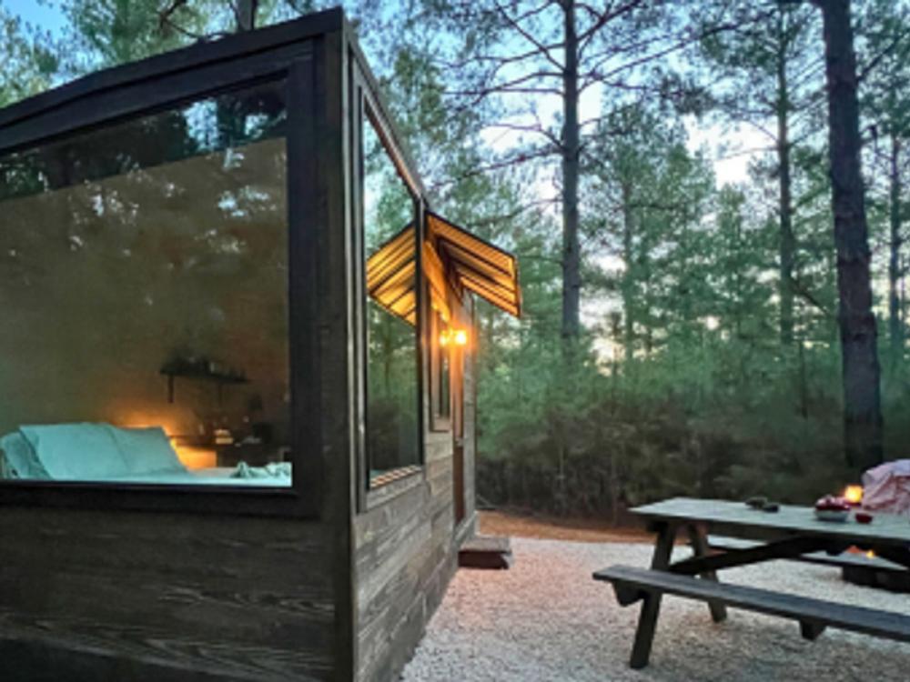 Cabin with picnic table in front at Tranquil Cabins
