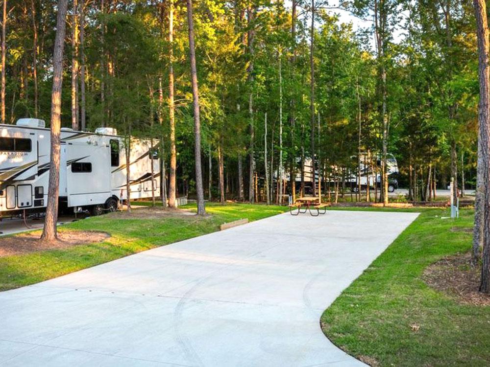 A paved RV site and picnic table at WOODLAND CREEK RV PARK