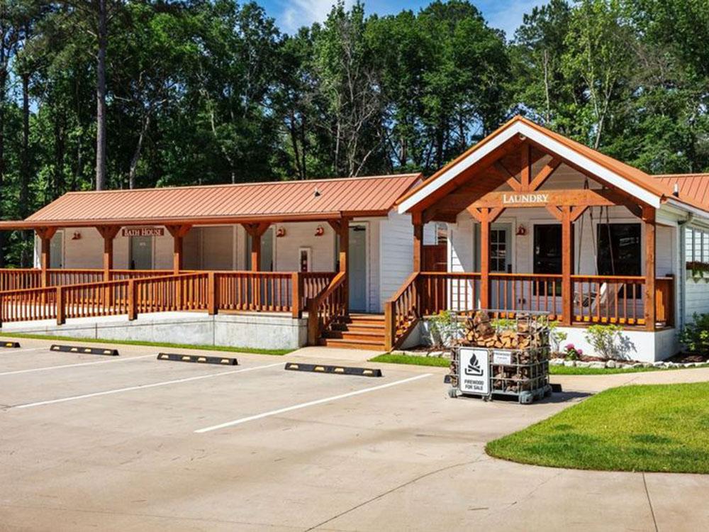 Exterior of laundry building and firewood for sale at WOODLAND CREEK RV PARK