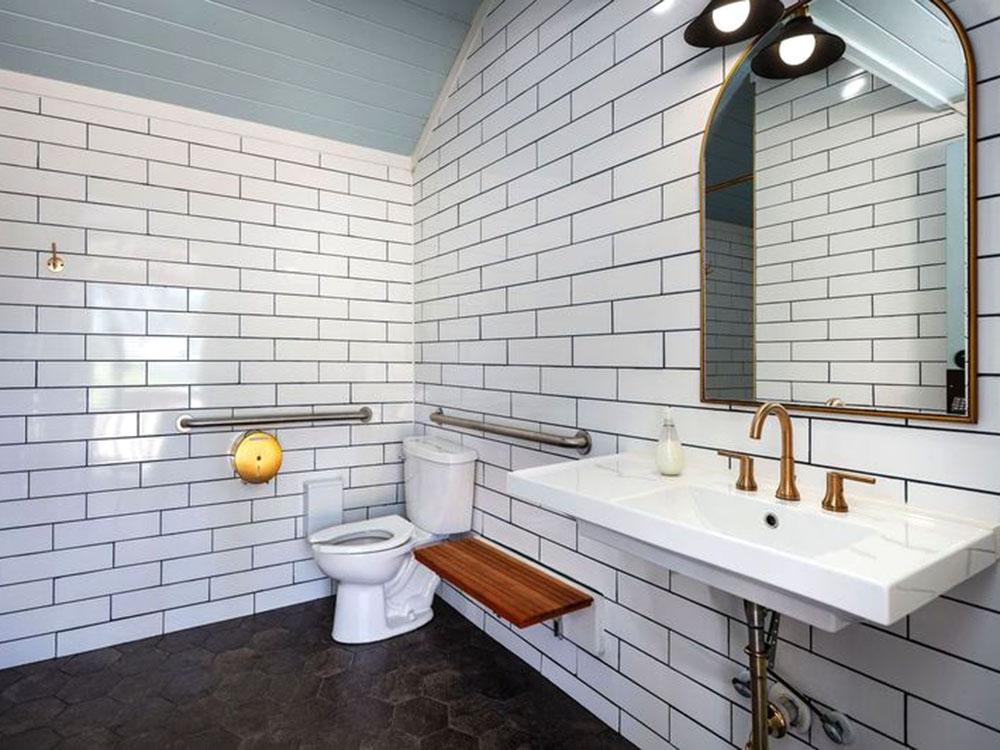 Interior of the white-tiled restroom at WOODLAND CREEK RV PARK