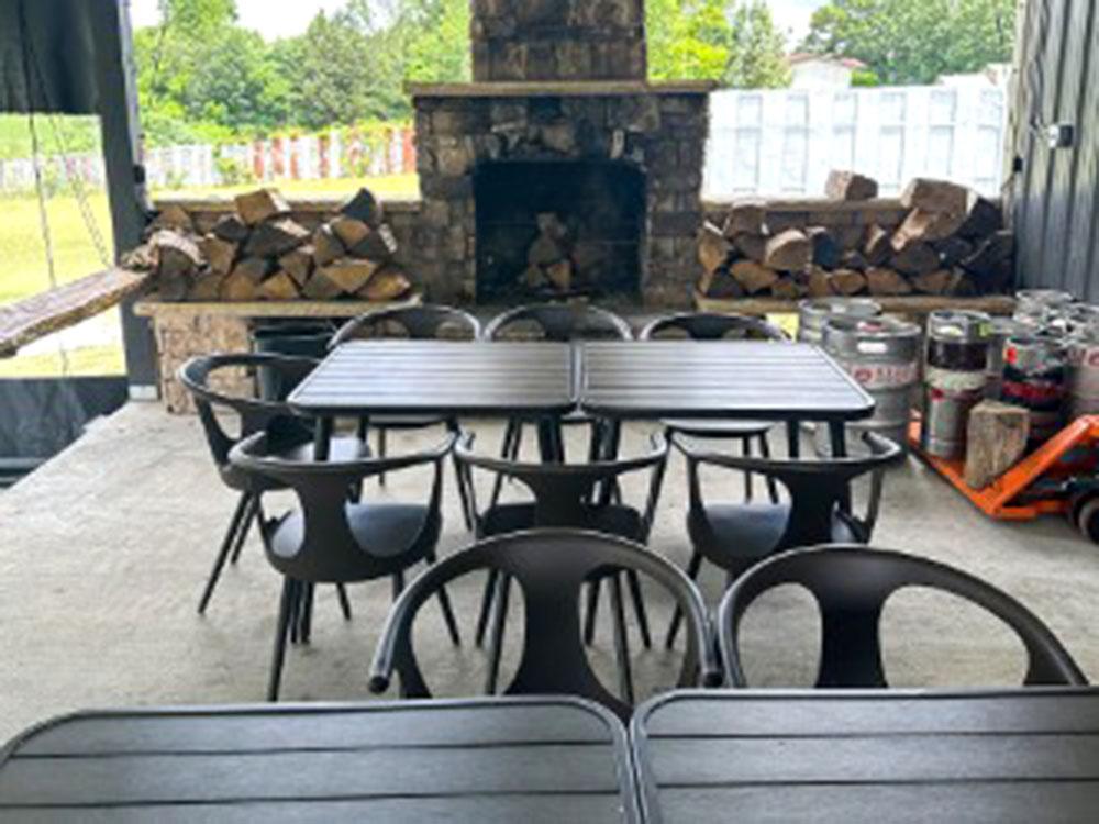 Table and chairs with a fireplace at FRANK'S AT CANE HOLLOW RV PARK