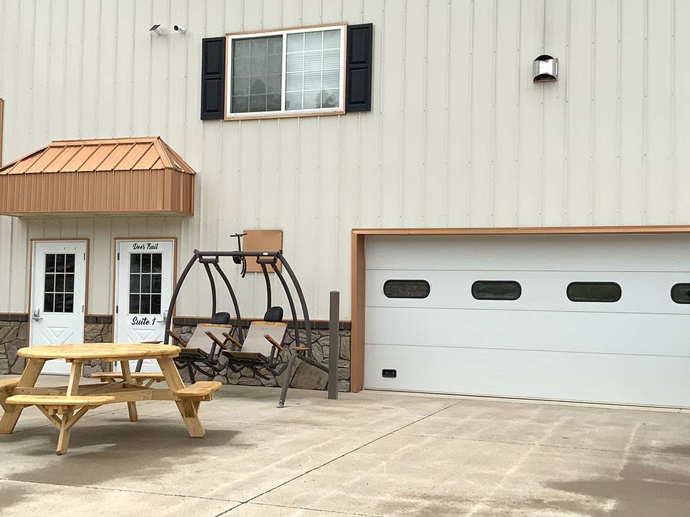 A patio swing and picnic table by the office at CanAmerican 85 RV Park