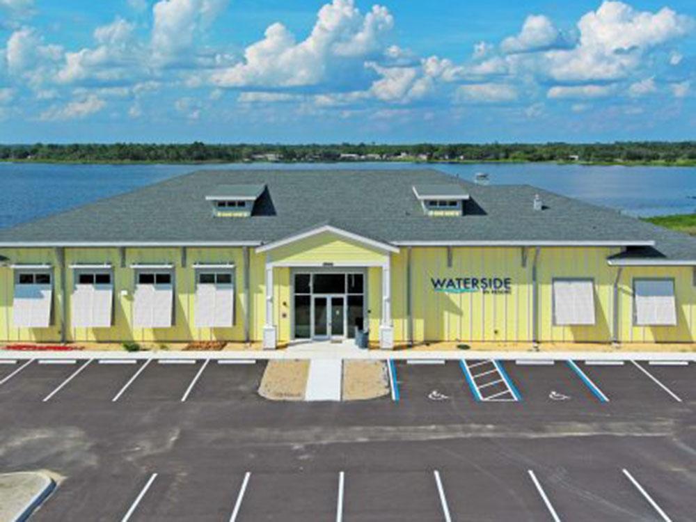 Exterior front of building with lake in the background at WATERSIDE RV RESORT