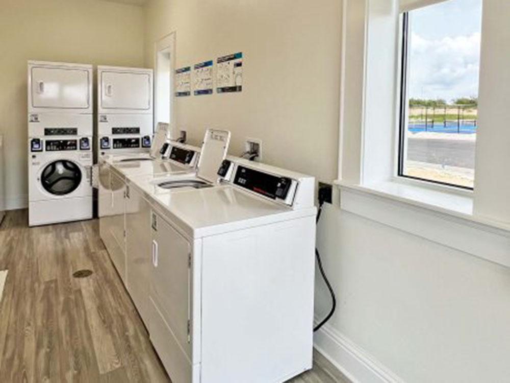 Laundry room with washer and dryers at WATERSIDE RV RESORT