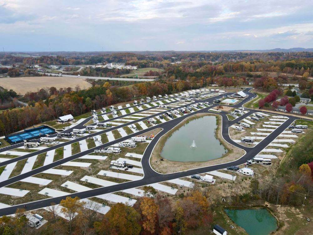 A view of the RV sites, pond and pickle ball courts at The Farm RV Resort