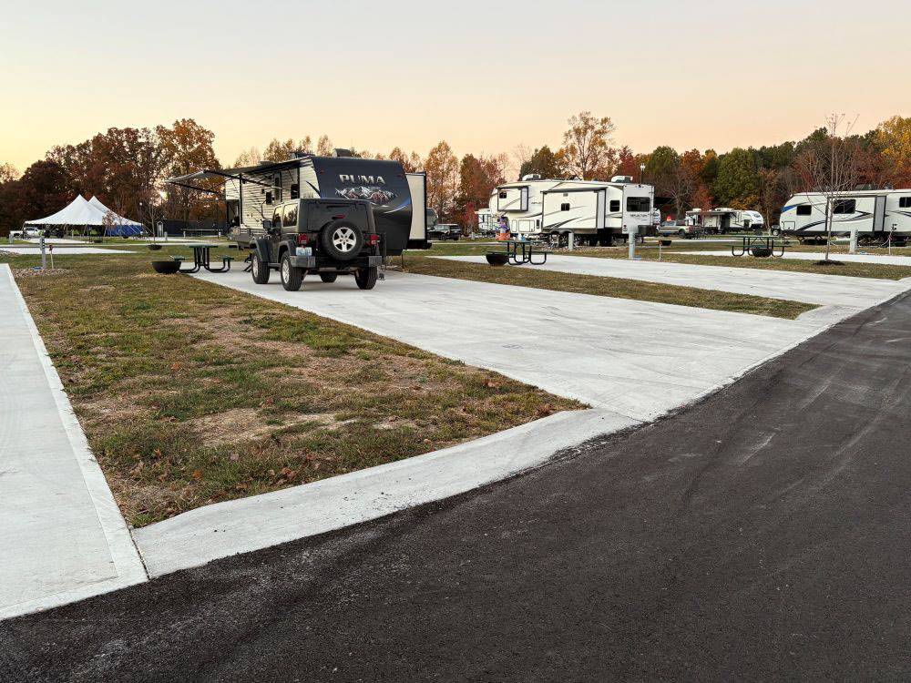 RVs parked in paved sites at The Farm RV Resort