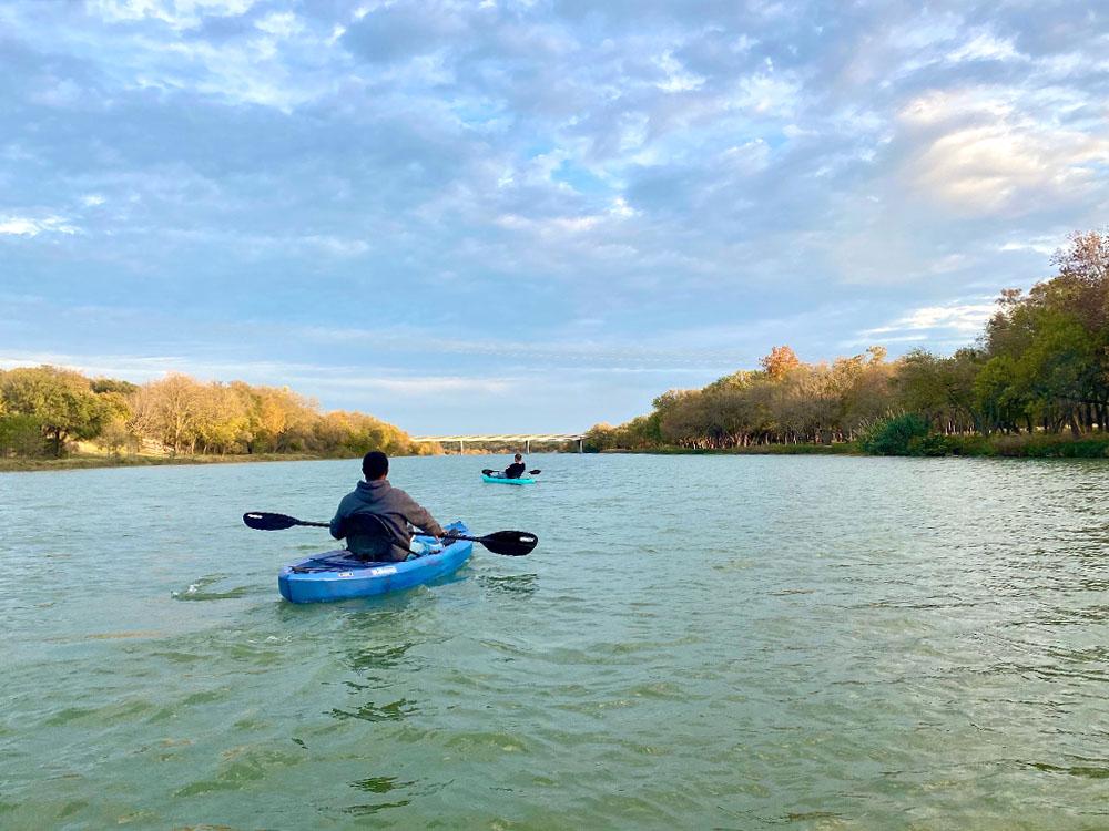 Man kayaking on the river at RIVER'S EDGE CAMPGROUND