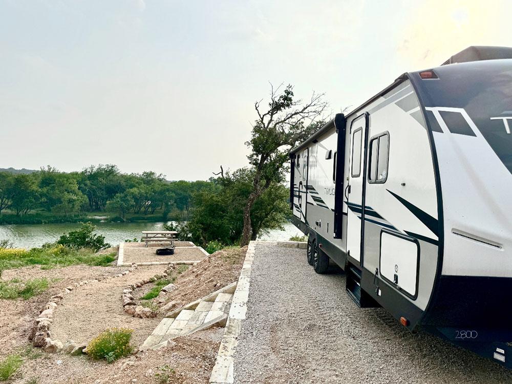 RV at site with a river view at RIVER'S EDGE CAMPGROUND