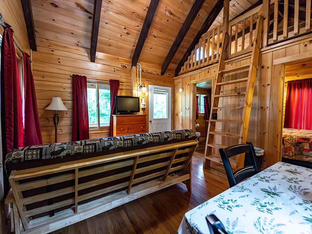 Cabin interior with loft at RIVER MEADOW CAMPGROUND