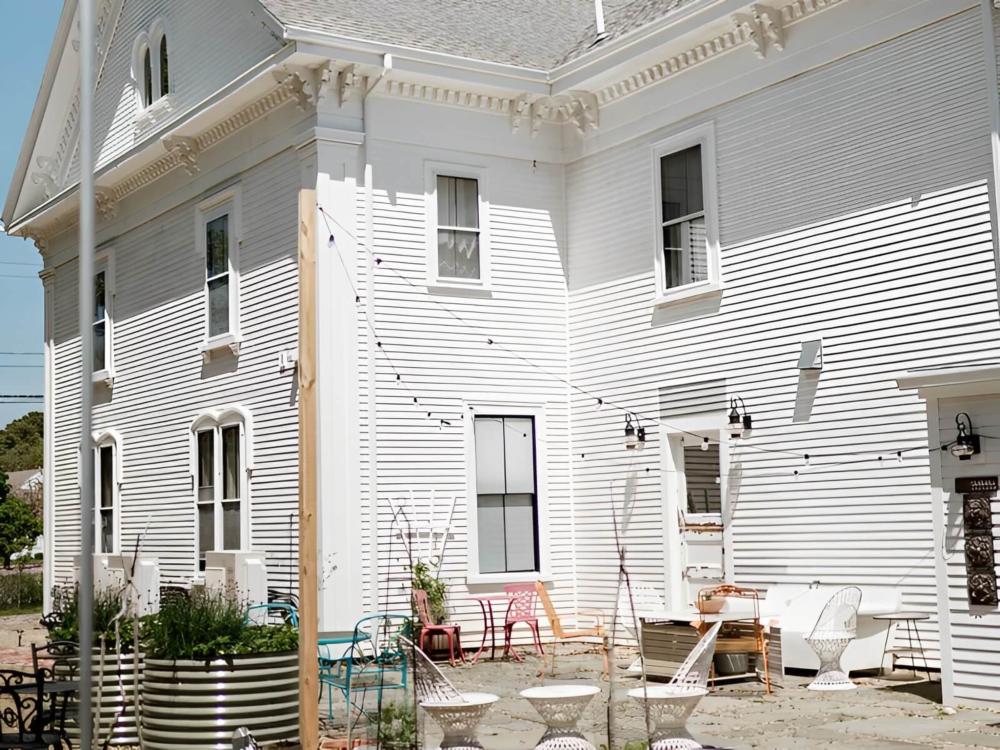Side view of the home with seating area at The Arrival Bed & Breakfast