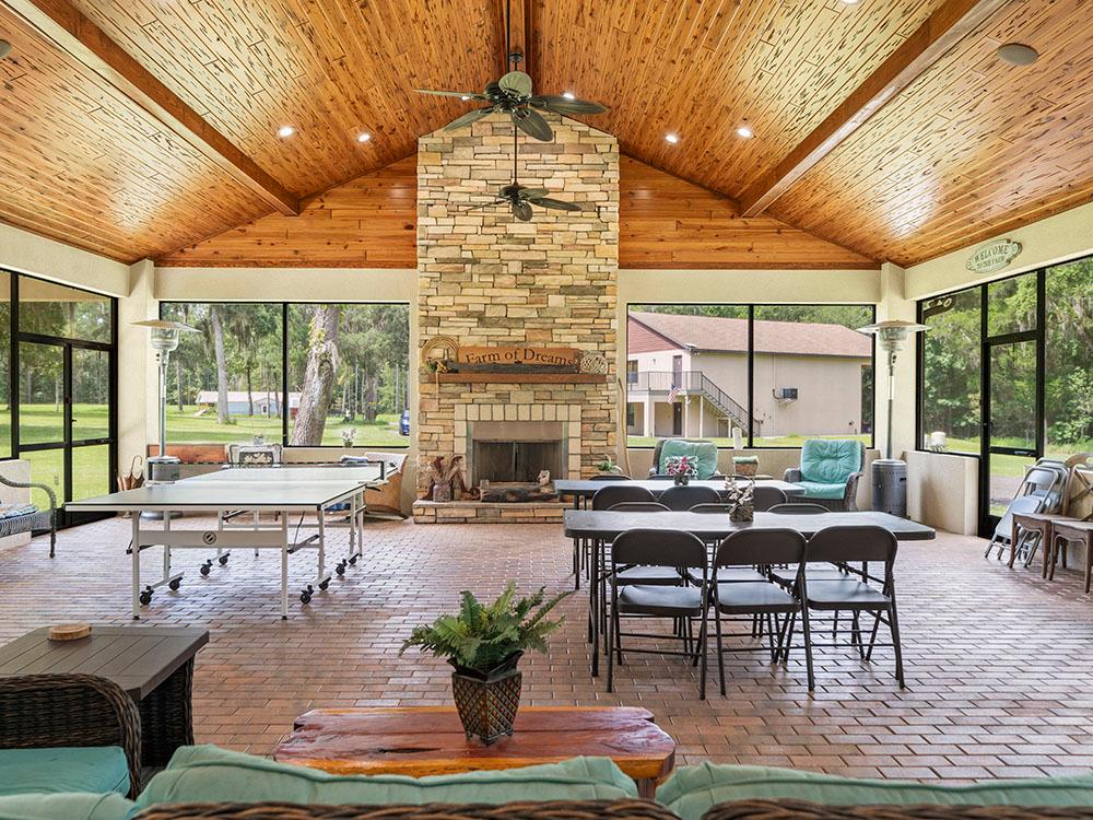 Interior of the rec hall with stone fireplace at FARM OF DREAMS RESORT