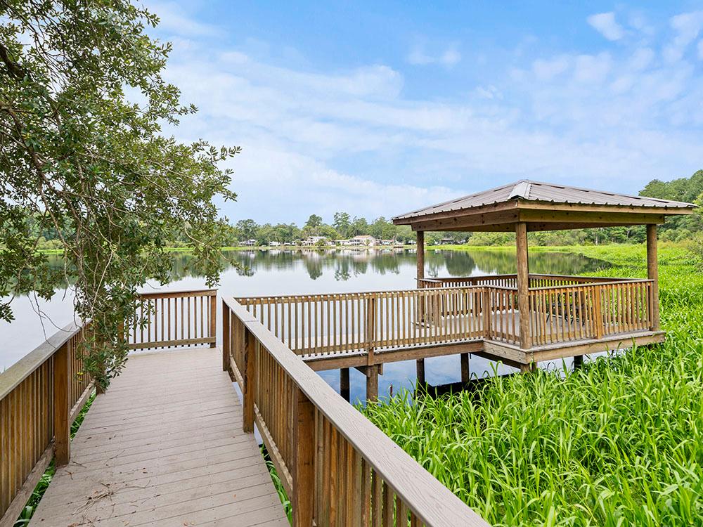 A pier leading to a gazebo on the water at FARM OF DREAMS RESORT