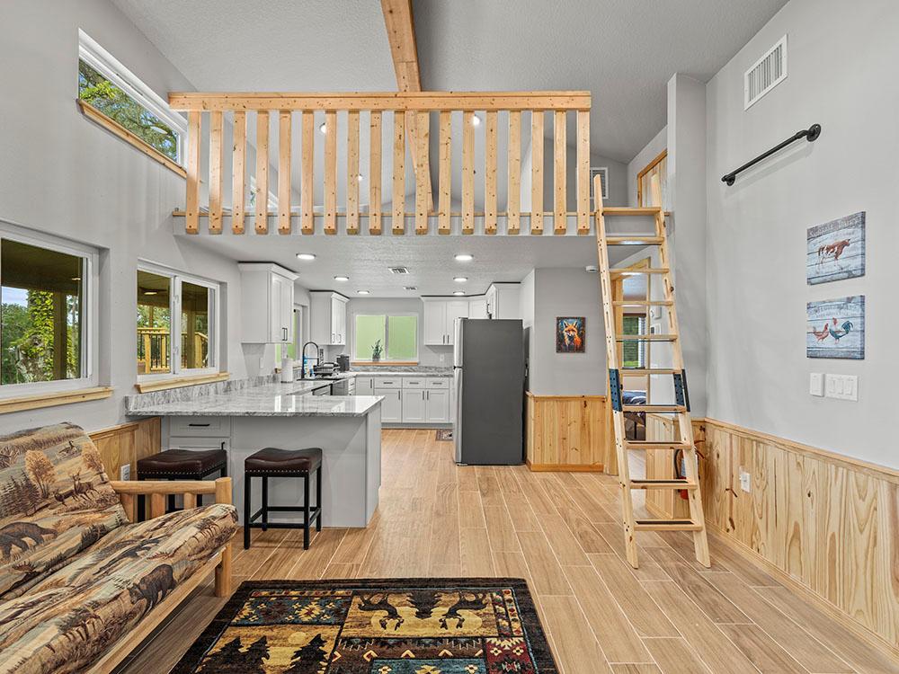 Interior of a rental cabin with a loft at FARM OF DREAMS RESORT