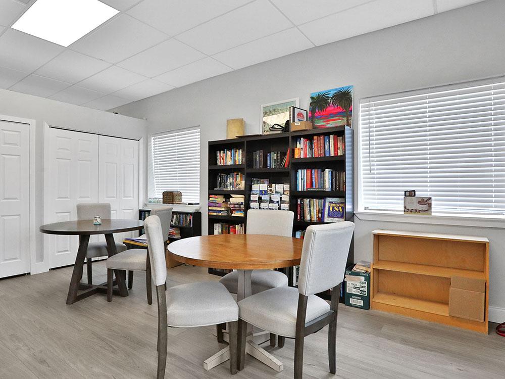 Seating area with book shelves at HARBOR VIEW ON THE BAY