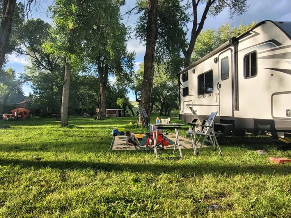 Child playing at a grass site at The Oasis RV Park