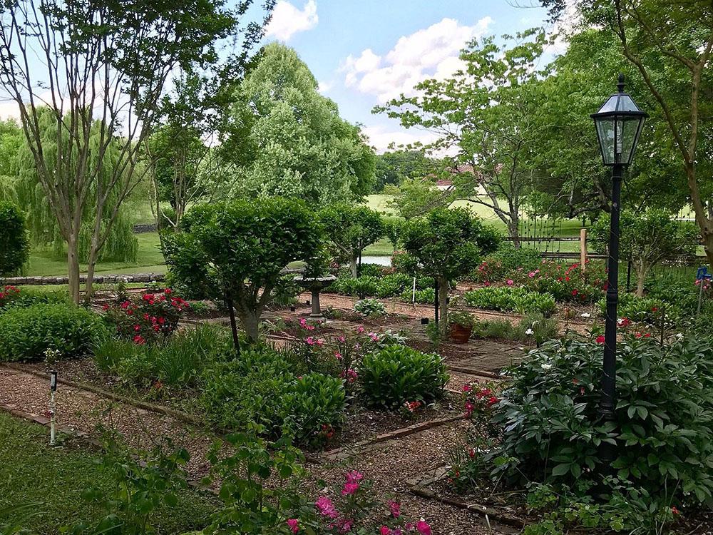 Garden with walking path at ROCK WALL RV PARK