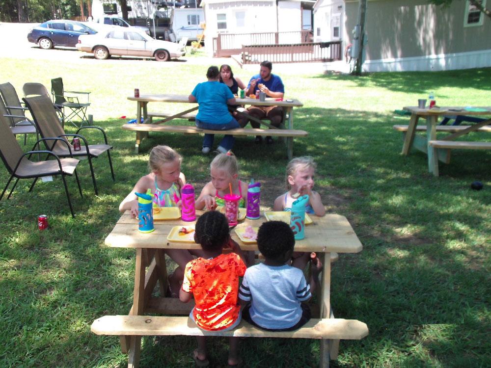 Little kids at a little picnic table at PINE RIDGE RV PARK