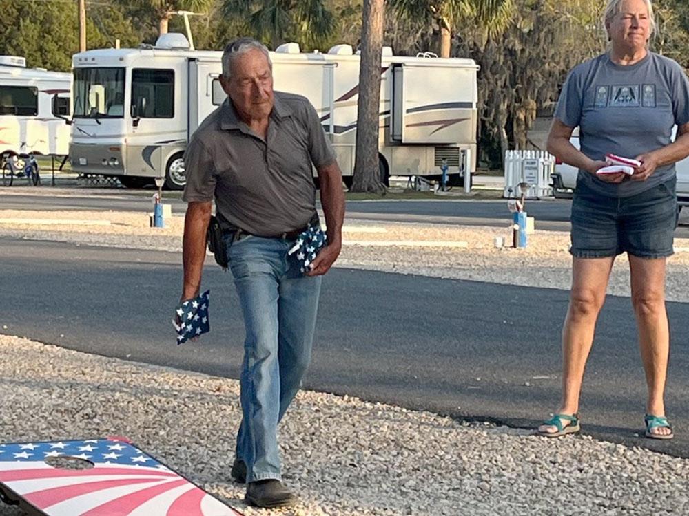 A couple playing corn hole at STEINHATCHEE VILLAGE RV PARK