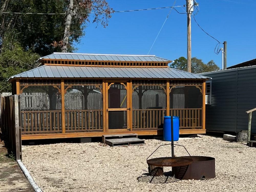 Enclosed pavilion with a fire ring in front at STEINHATCHEE VILLAGE RV PARK