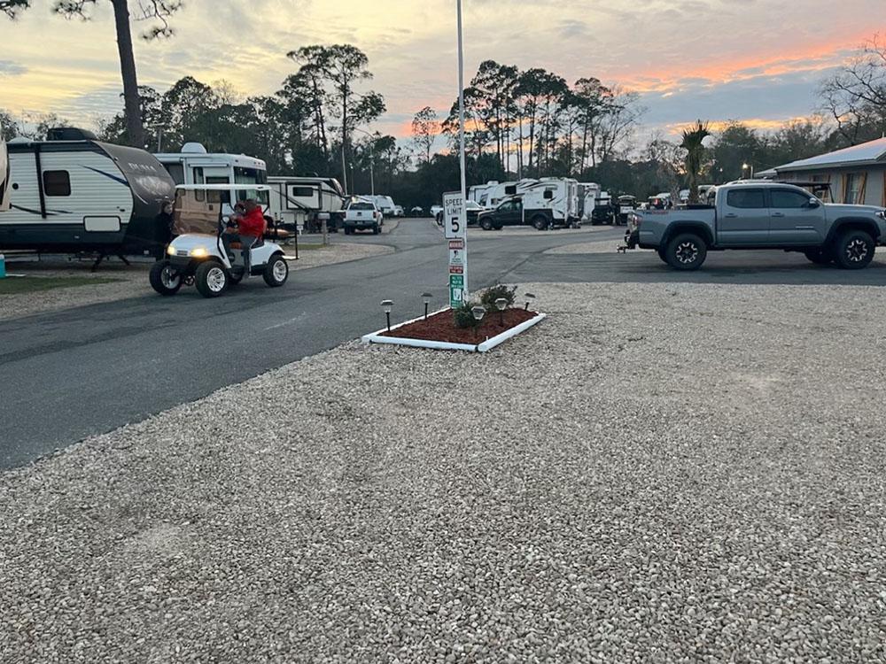 A person on a golf cart riding through the park at STEINHATCHEE VILLAGE RV PARK