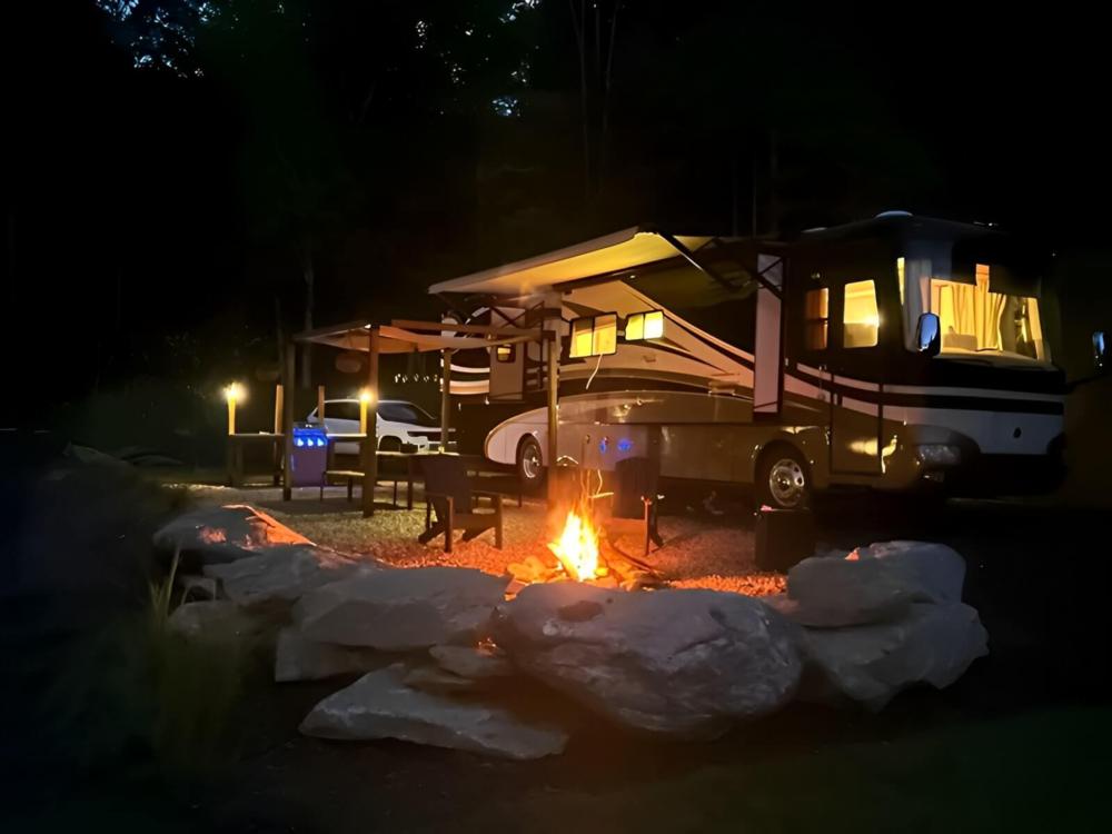 RV parked near fire pit at The Barlow RV Park