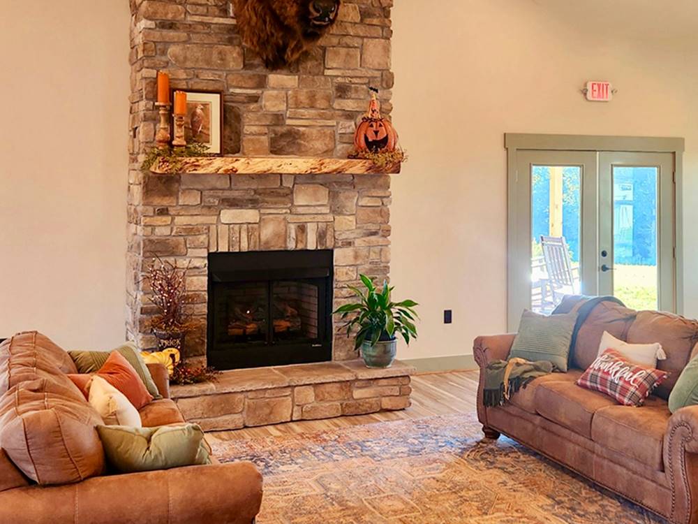 Seating area at a fireplace at The Oaks RV Resort