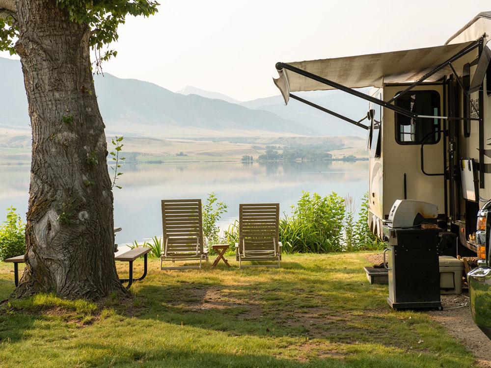 RV with open awning at LAKESHORE CABINS AND CAMPGROUND