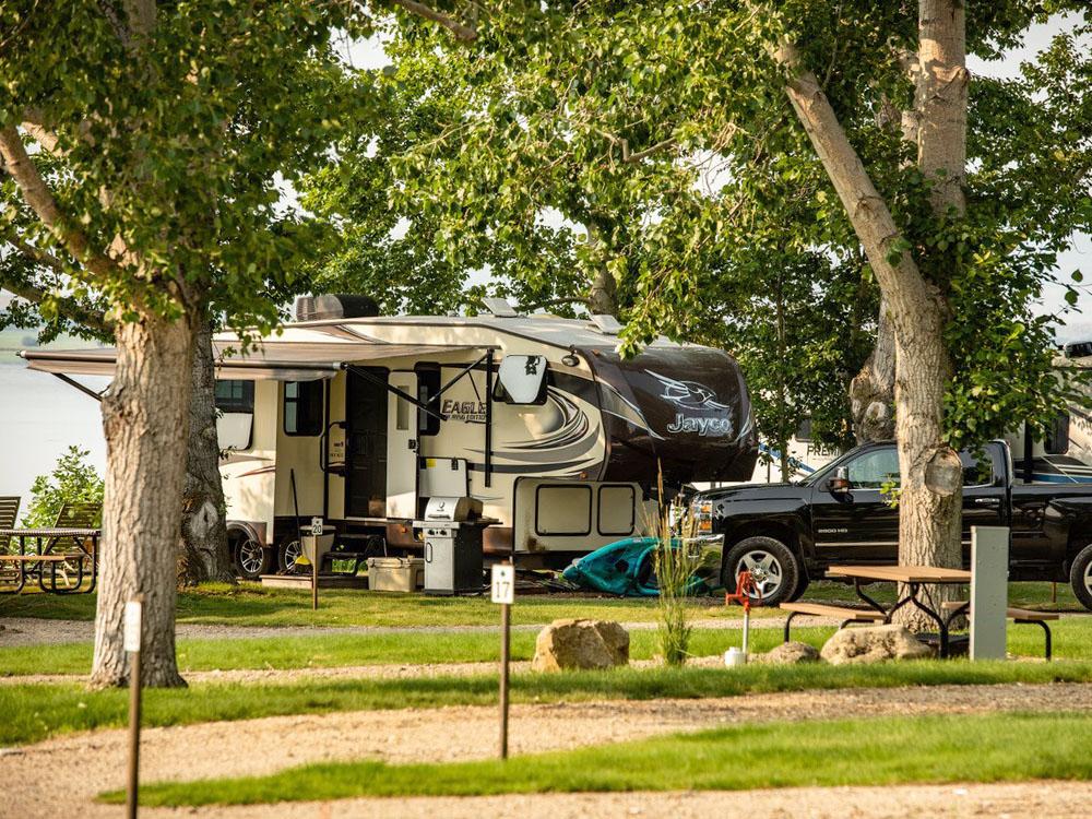 Shaded RV site at LAKESHORE CABINS AND CAMPGROUND