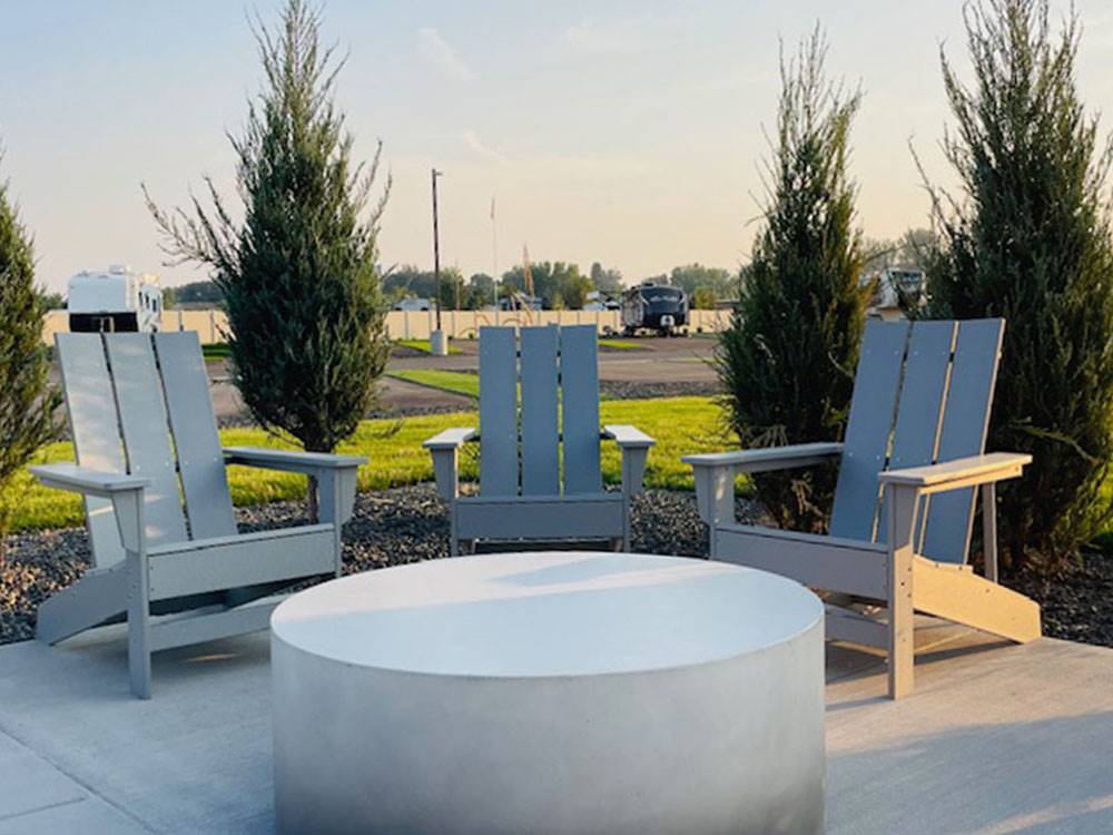 A patio with Adirondack seating at Sun Creek Point RV Park